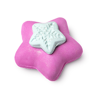 A pink star shaped bath bomb filled with small spherical pink and yellow balls with a white little star on top on a bright background