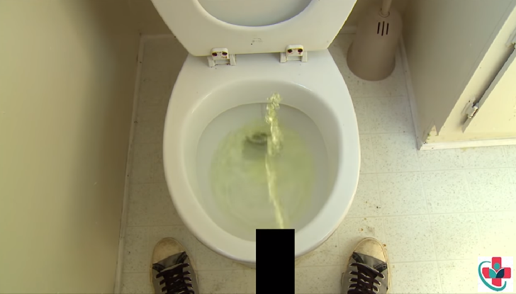 Man urinating in the toilet