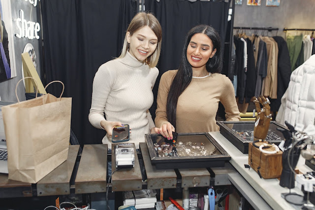 Two girls shopping at a jewelry store.