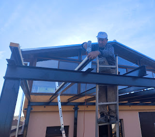 Bekir fixing the wooden beam in place