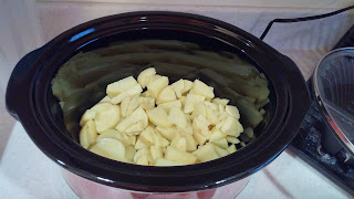 peeled and cut potatoes in the bottom of the slower cooker