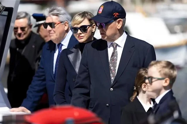 Princess Charlene wore a navy cashmere vest by Loro Piana. Princess Gabriella wore a double breasted blazer by Ralph Lauren