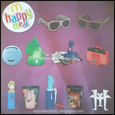 McDonalds Hotel Transylvania 3 Toys 2018 UK Set of 10 - Wayne Fashion Glasses, Murray Fashion Glasses, Frank Ball, Blobby Luggage Tag, Kraken Activity Card Set, Camera Viewer,  Giggling Backscratcher, Drink with Drac Cup, Vacation Travel Tool and Drac cup happy meal toy