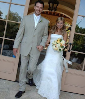 Tiffani Thiessen with her husband Brady Smith in their wedding dress