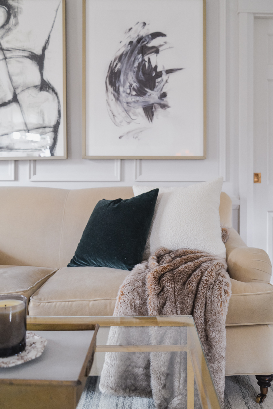 winter living room decor with velvet sofa, faux fur throw, velvet pillow and boucle