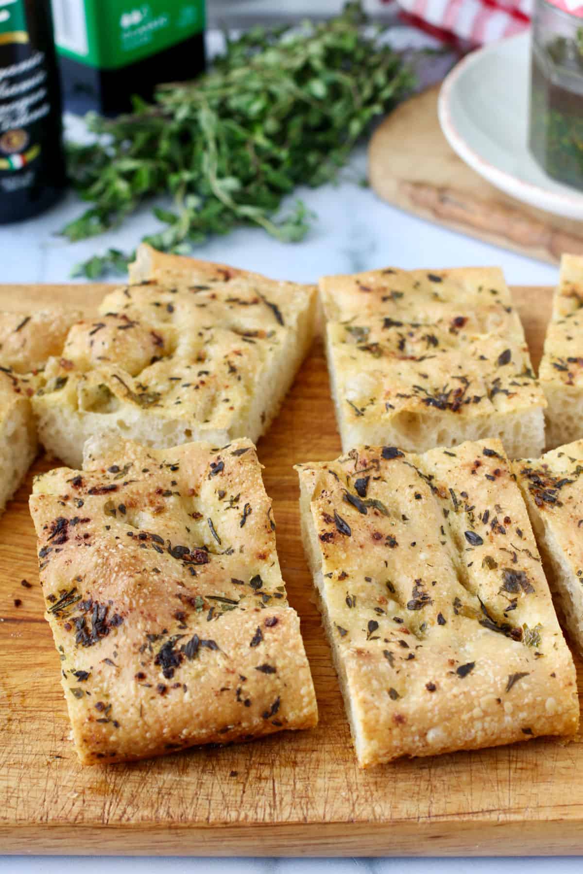 Herb Olive Oil Focaccia Slices on a cutting board.