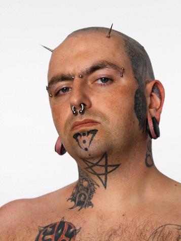 Basic star tattoo on man's front neck