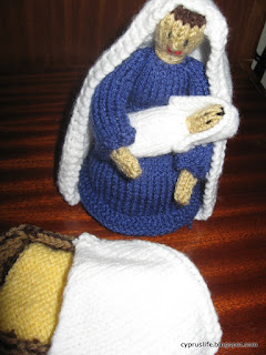 knitted Mary, baby and the manger with its rug.  Knitted Nativity pieces.