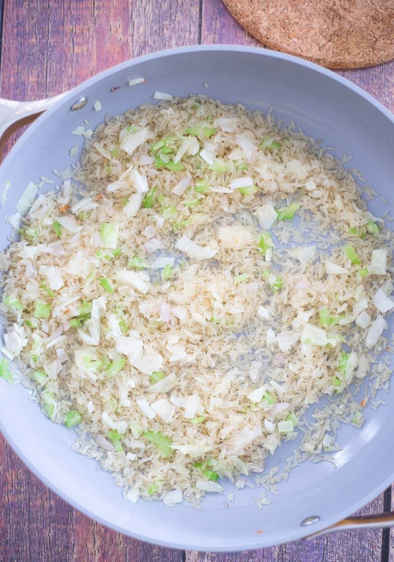 Long-grain rice added to the sauteed onions.