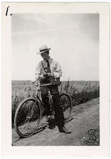 Lot 045 v1p17.1, View of Edgar Syverud with his bicycle and a camera in hand