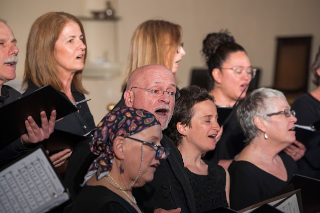 Director Pierre Massie sings with the choir in the tenor section