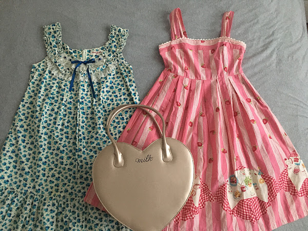 two cute dresses and a bag in the shape of a heart