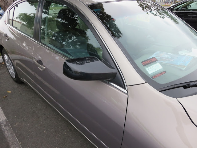 2012 Nissan Altima with recycled door and new mirror at Almost Everything Auto Body