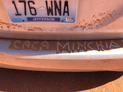 An invented Italian swear word written in the dust on the back of our van on the Valley Drive in Monument Valley.