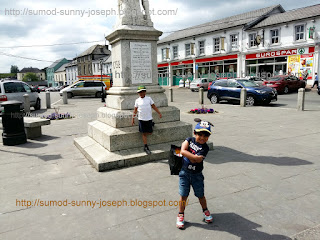 Pictures behind Michael Dwyer Monument Statue with Eurospar Quinns of Baltinglass beside it