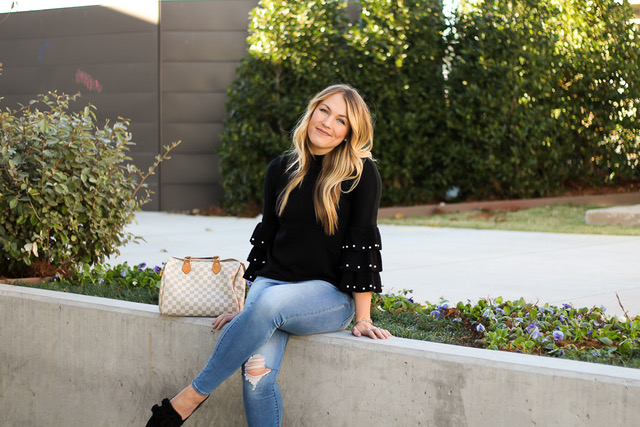 girl sitting outdoors smiling in the sunlight 