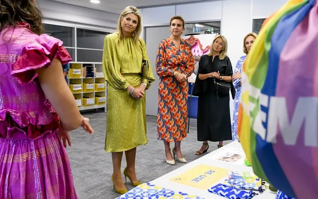 Queen Maxima wore a yellow dress by Natan. Queen Maxima and Minister for the Environment Vivianne Heijnen