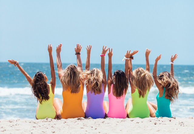 https://www.pexels.com/photo/back-view-photo-of-six-girls-wearing-swimsuit-sitting-on-white-sand-2647973/