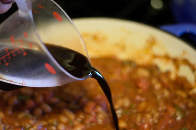 Worcestershire sauce being added to the pot. 