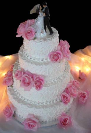 A gorgeous buttercream wedding cake with beautiful pink silk roses for