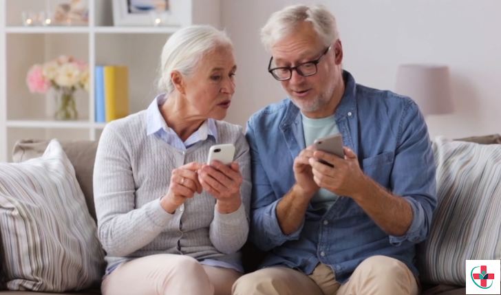 Aged couple checking phones