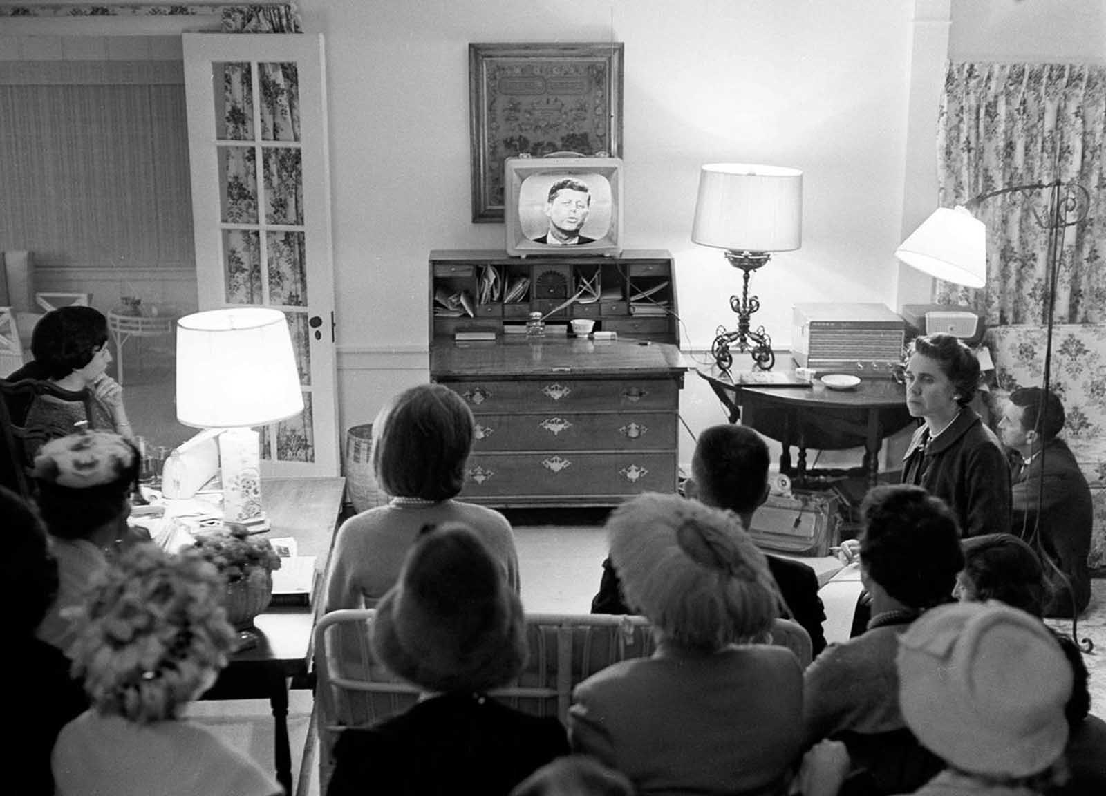 Jacqueline Kennedy, left center, sits in her living room with a group of Democrats watching her husband on television, debating domestic affairs with Vice President Richard Nixon, at her Hyannis Port, Massachusetts, home, on September 26, 1960.