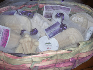 Close up picture of the gift basket my Raiser made. (Homemade goat milk soaps). A cute Lab puppy, dog bones, luffa, waves and such