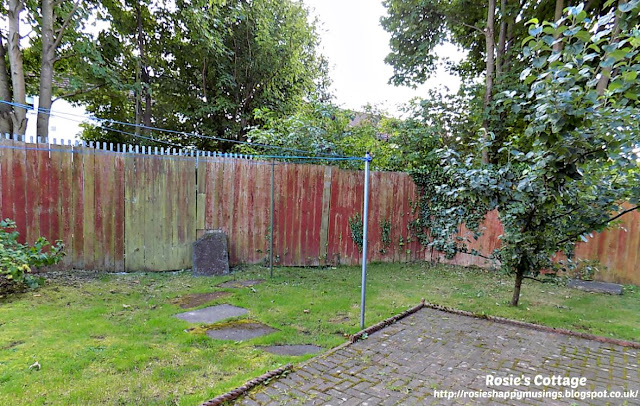 Very wide and tall fence at the back of the garden before being re-built