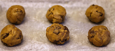 Raw balls of Nutella and hazelnut-stuffed browned butter chocolate chunk cookies
