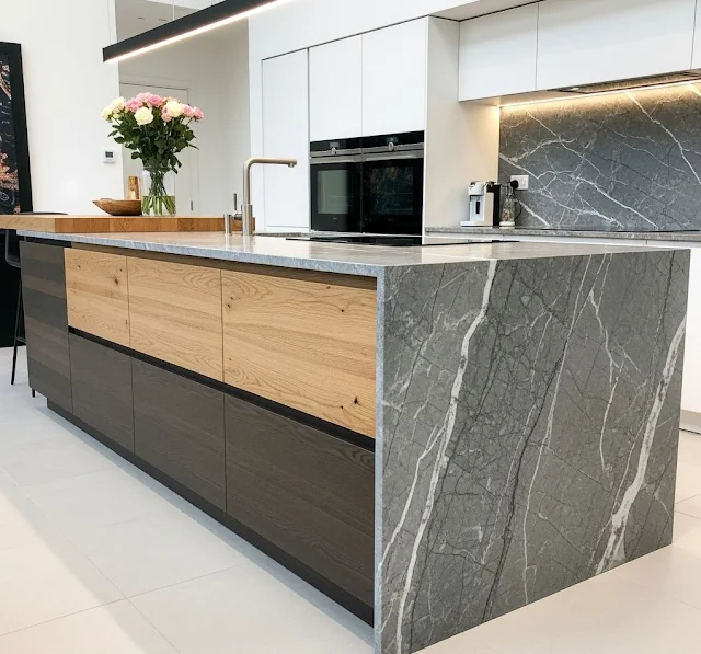 Modern kitchen island with two-tone wood base and stone waterfall countertop