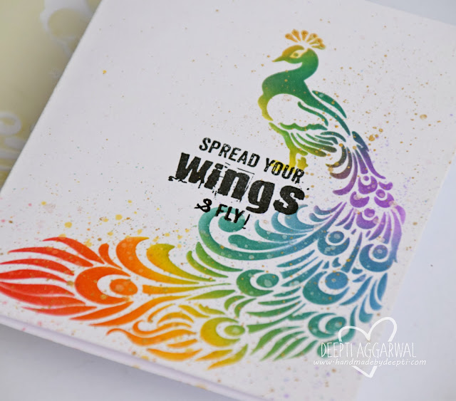 close up of a Encouragement  handmade card  depicting rainbow colored peacock