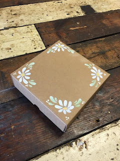 Add daisies to gift boxes 