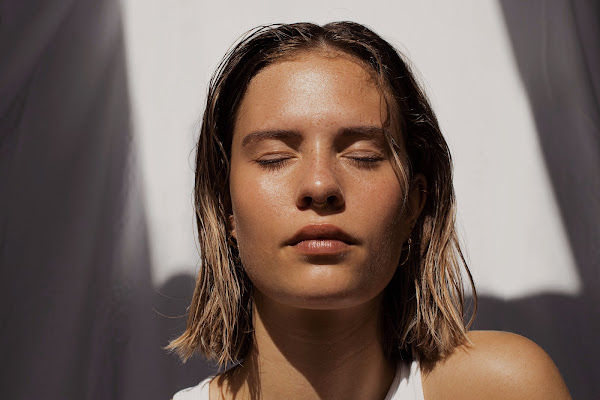 woman basking face in sun