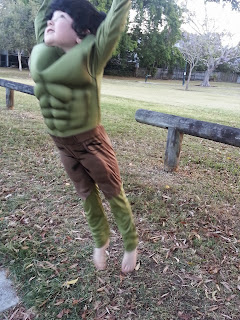 Photo of boy in hulk costume, jumping.