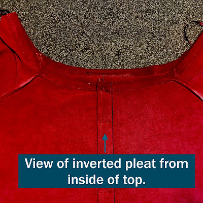 Red top turned inside out with view of the back of the inverted pleat.