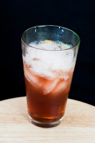 Sex on the sidewalk cocktail, vodka, melon liqueur, midori, chambord, black raspberry liqueur, cranberry juice