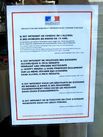 Obligatory legal notice on the door of a restaurant about the serving and consumption of alcohol.  Indre et Loire, France. Photographed by Susan Walter. Tour the Loire Valley with a classic car and a private guide.