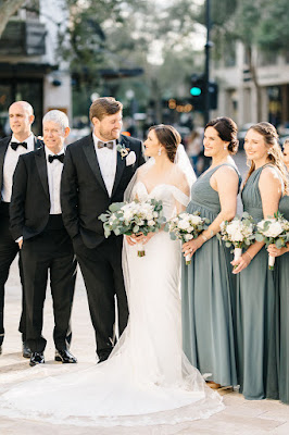 bride and groom smiling with bridal party