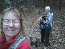 hikers holding small dogs