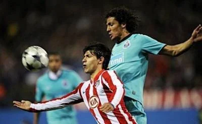 Atletico Madrid forward Sergio Aguero vies with FC Porto's Bruno Alves