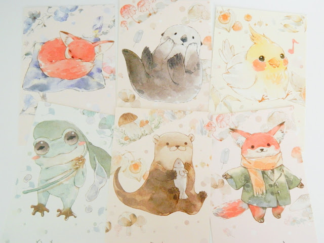 a photo showing six watercolour animal illustration postcards