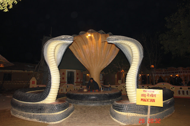 Photo of A magician sitting inside his fancy enclosure in the tourist village of Chokhi Dhani