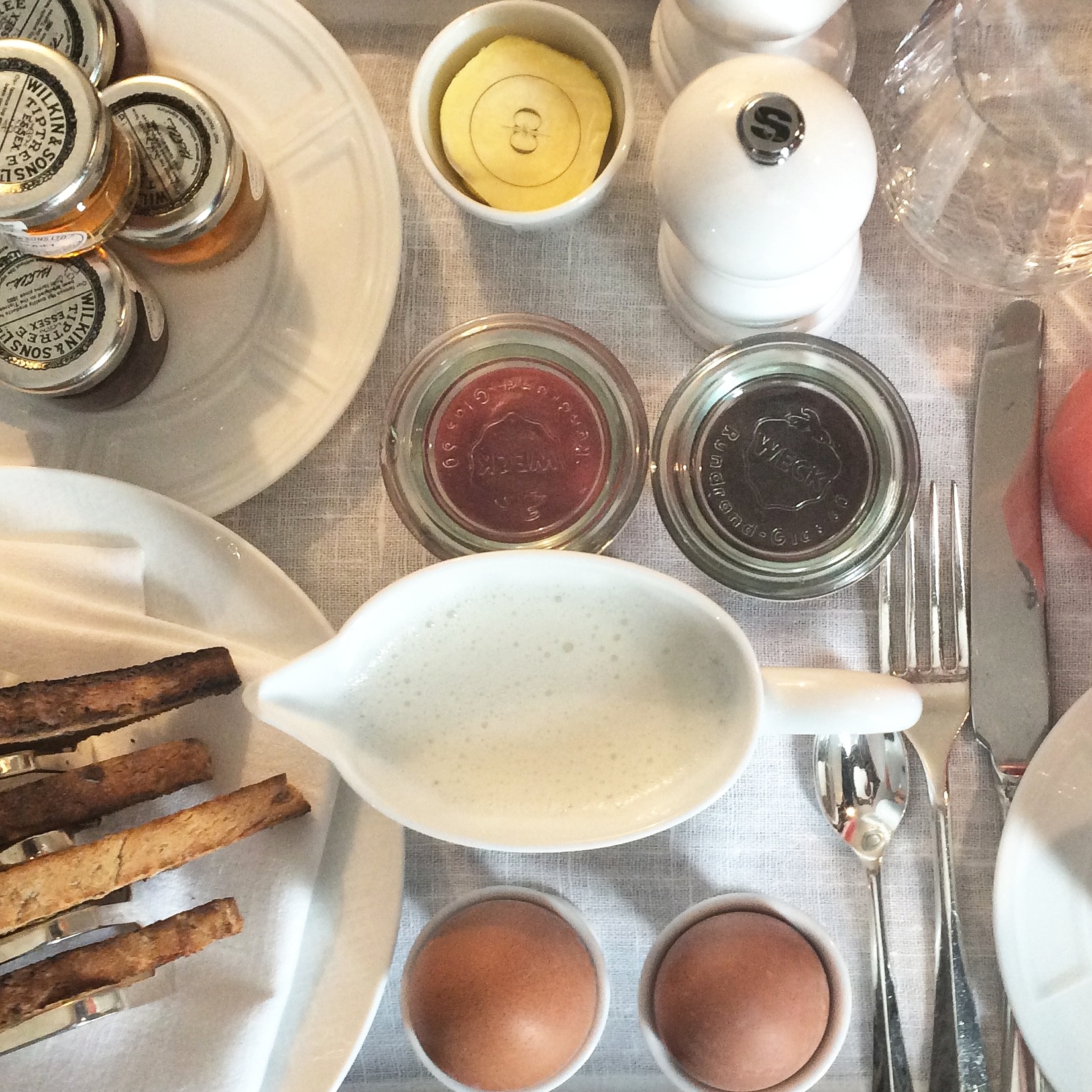 boiled eggs, toast, jams and juice on a tray at the rosewood london hotel