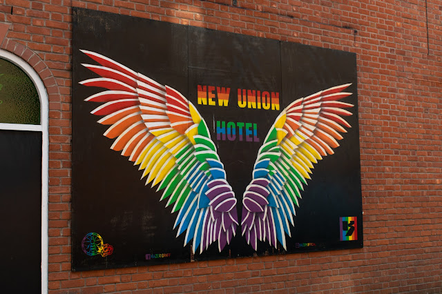 Rainbow wings pained on a wall
