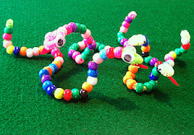 Tessa's pony bead snake family. Note her use of pattern on the mommy snake.