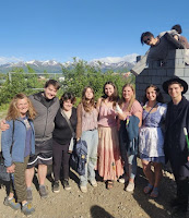 Group of people standing in front of mountains and blue sky at Renaissance Fair
