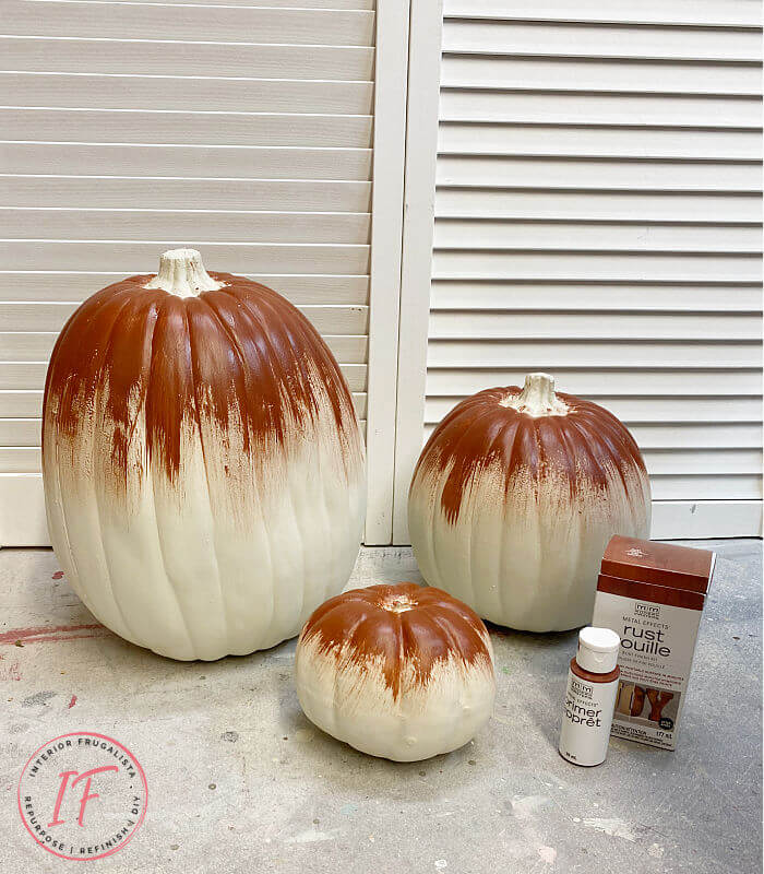 Unique Rust Paint Dripped Abstract Pumpkin Topiaries with white artificial stacked pumpkins and rust activated paint to decorate outdoors for fall.