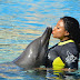 More Photos From Ini Edo’s Vacation In Dubai, See Her Kiss A Dolphin.