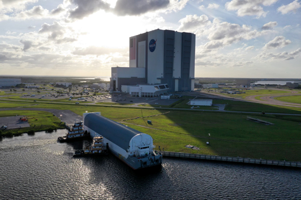 With the Space Launch System's core stage booster for Artemis 1 onboard, NASA's Pegagus barge docks at Kennedy Space Center's turn basin wharf...on April 27, 2021.