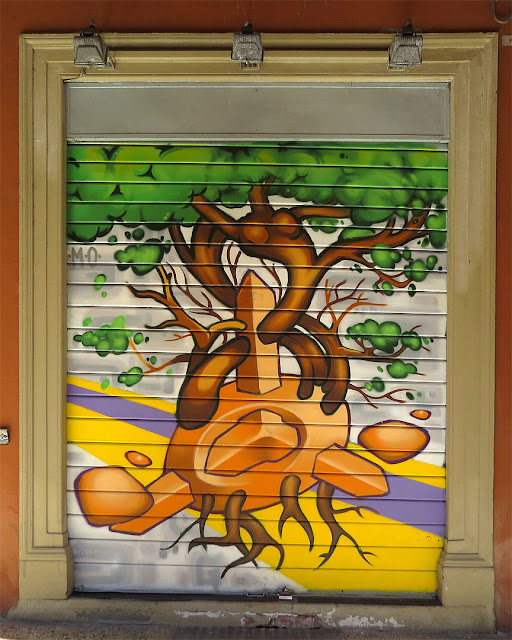 Rolling shutter painted with a mural, porticoes of Via Galliera, Bologna